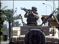 A US army soldier in the turret of a Humvee in Baghdad