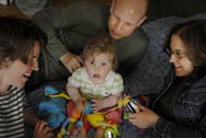 Baby Helen is surrounded by her three parents - Lauren Gillingham, left, Alex Irwin and Julie Murray - who have signed a co-parenting contract.