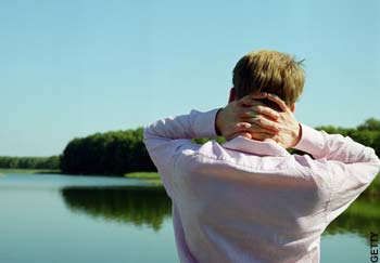 Picture posed by model of man looking out across lake