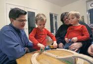 Mel Rutherford, left, and Melanie Parish play with their twin boys. Both women wanted a biological link to their children and so they opted for inter-spousal egg donation