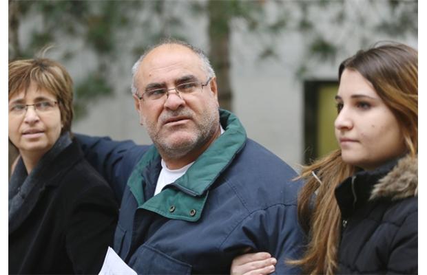 Suspended taxi driver Nidal Zeiti, 52, walks outside the Elgin Street courthouse with his wife Sana Daod and 20-year-old daughter after receiving bail in Ottawa on Friday, November 15, 2013.